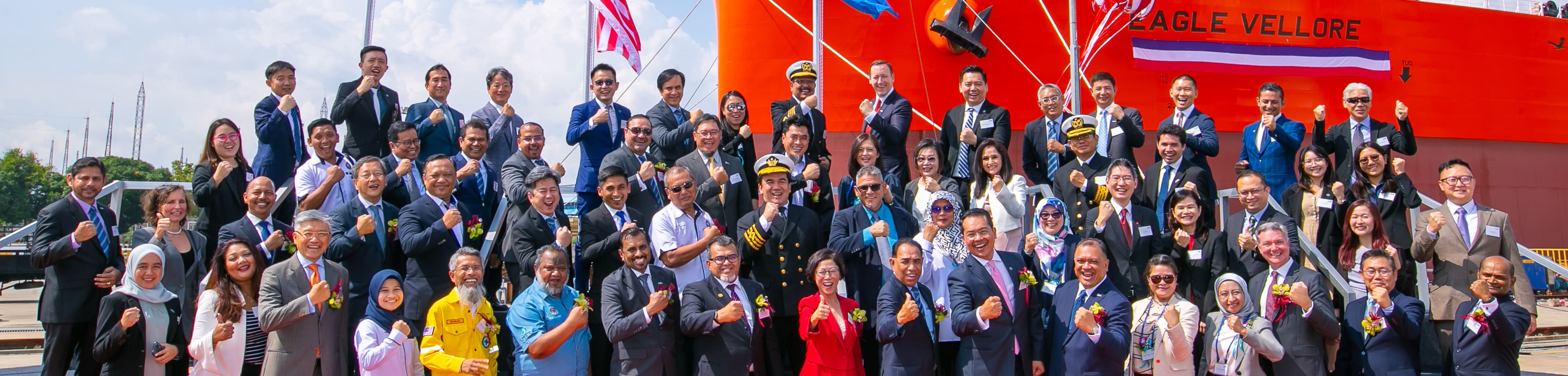 A group of people standing in front of LNG Dual-Fuel Very Large Crude Carrier Eagle Vellore at a shipnaming ceremony